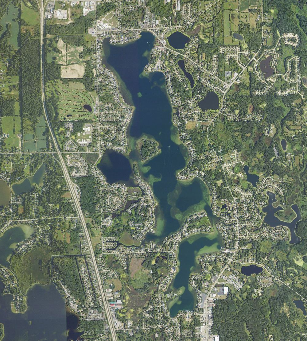 Aerial view of Lake Fenton in Fenton Charter Township, Michigan, from north to south, with US-23 along the left side