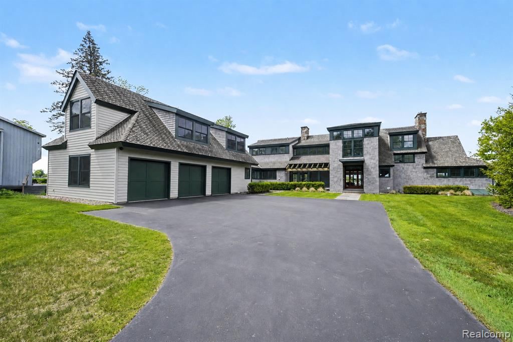 Front of the home with attached garages and an asphalt driveway