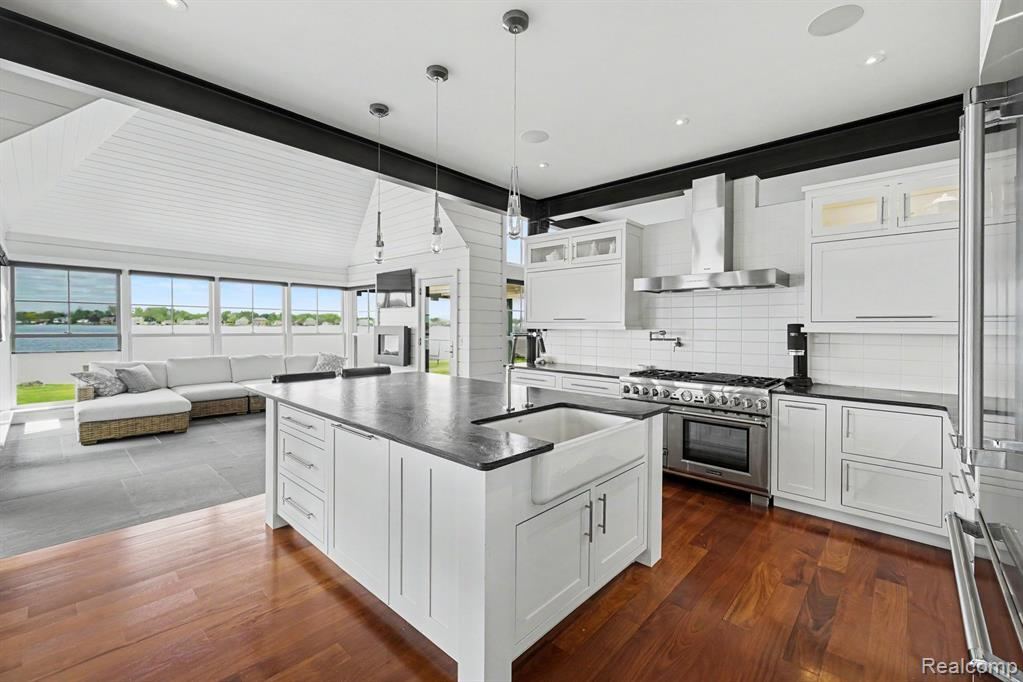 White kitchen with a center island, premium appliances and lake views