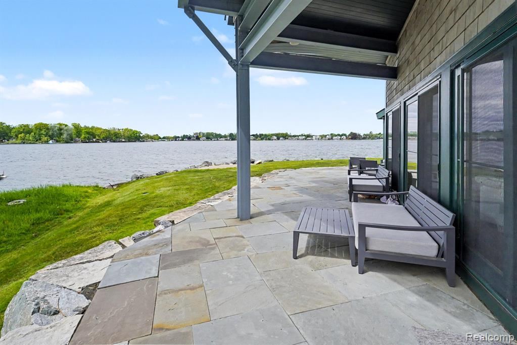 Covered stone patio looking out over Lake Fenton